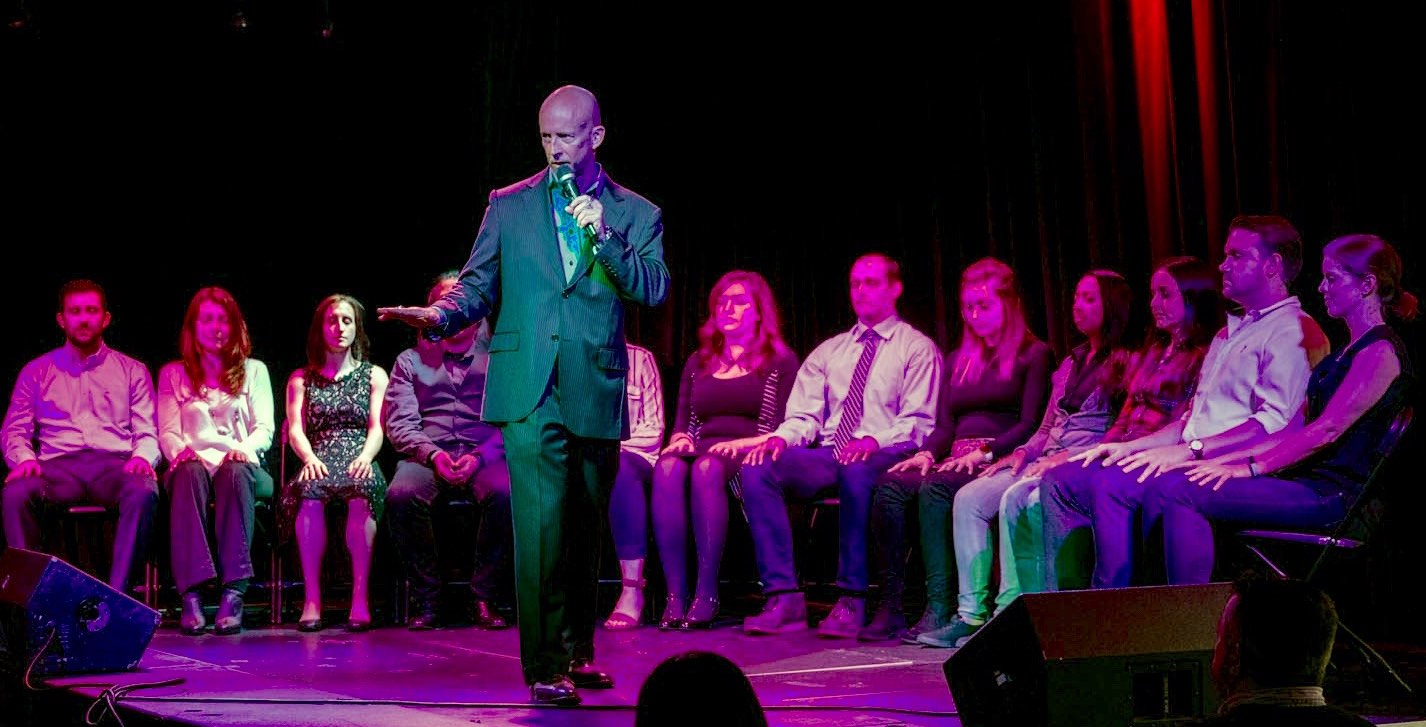 Corporate Entertainer Hypnotist Erick Känd Mesmerizes Audience at Employee Appreciation Event in Boston.